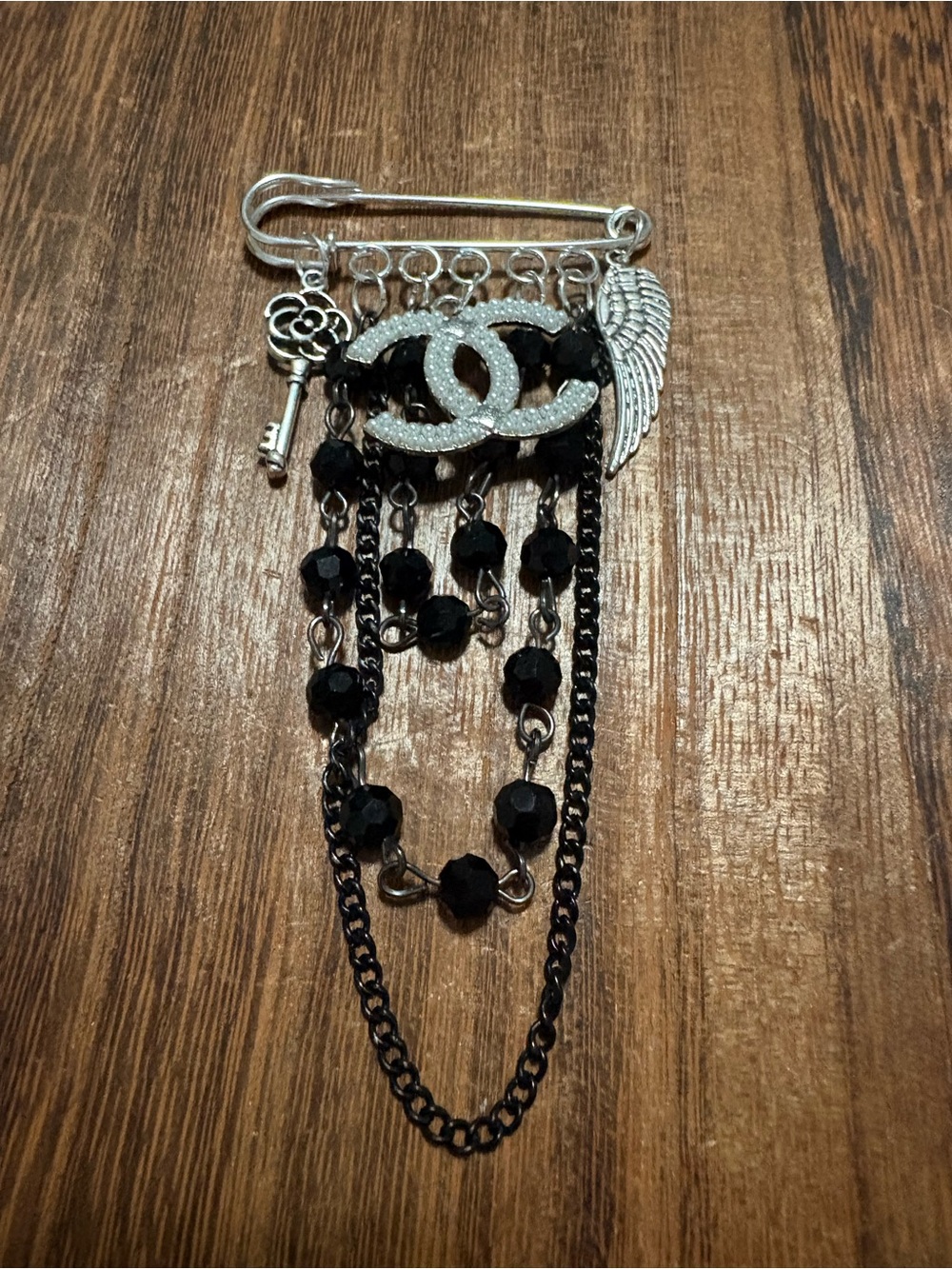 Silver-Tone Brooch with Black Beads, Wing and Key Charms